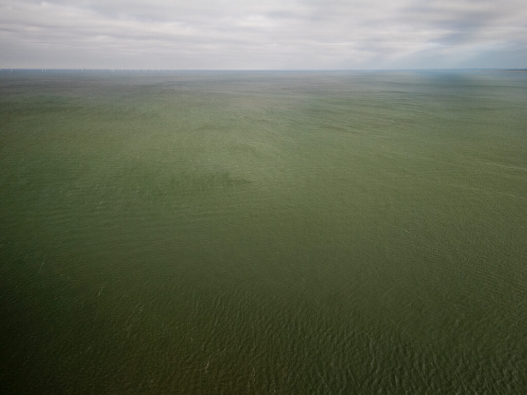 An overcast day over Liverpool Bay, featuring a vast expanse of water and a cloudy sky.